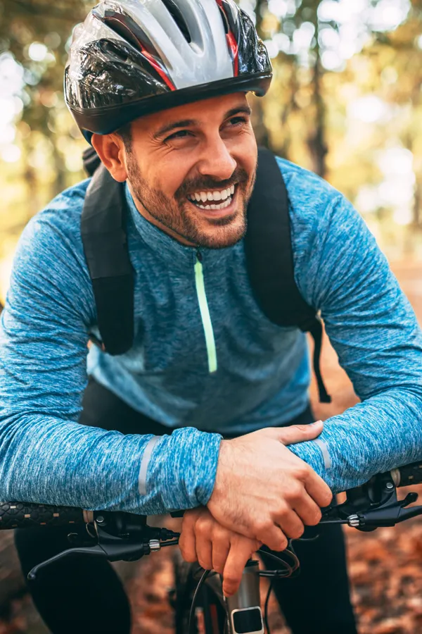 Adrenal-Hormone-Disorder-Treatment A smiling man getting ready for a cycling trip. Get treatment for adrenal hormone disorder from Healthy Aging Medical Centers of New Jersey in Northern New Jersey.