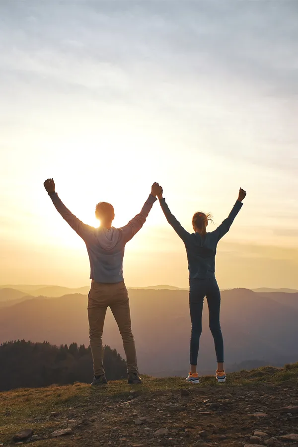 DHEA-Hormone-Treatment A couple raises their hands in triumph on a mountaintop. Get DHEA hormone therapy from Healthy Aging Medical Centers of New Jersey in Northern New Jersey.