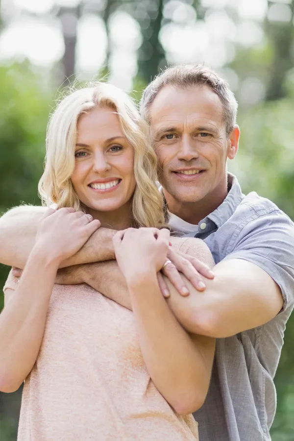 HGH-Hormone-Treatment A middle-aged couple embrace outdoors on a sunny day. Get HGH hormone therapy from Healthy Aging Medical Centers of New Jersey in Northern New Jersey.
