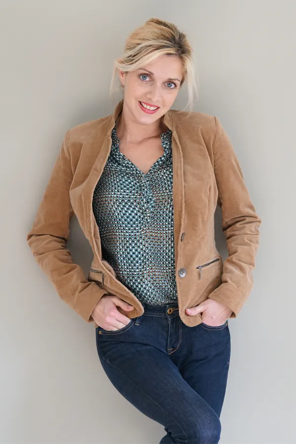 Metabolic-Syndrome-Treatment A smiling blonde woman in a tan leather jacket leans against a gray wall. Schedule metabolic syndrome from Healthy Aging Medical Centers of New Jersey in Northern New Jersey.