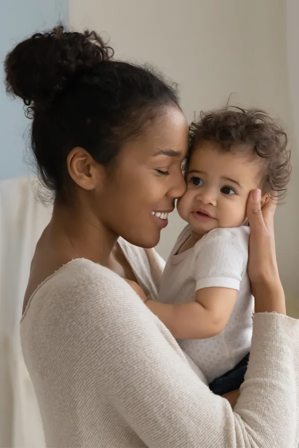 Postpartum-Hormone-Imbalance-Treatment A black woman happily touches her forehead to her infant's head. Get treatment for postpartum hormone imbalance from Healthy Aging Medical Centers of New Jersey in Northern New Jersey.